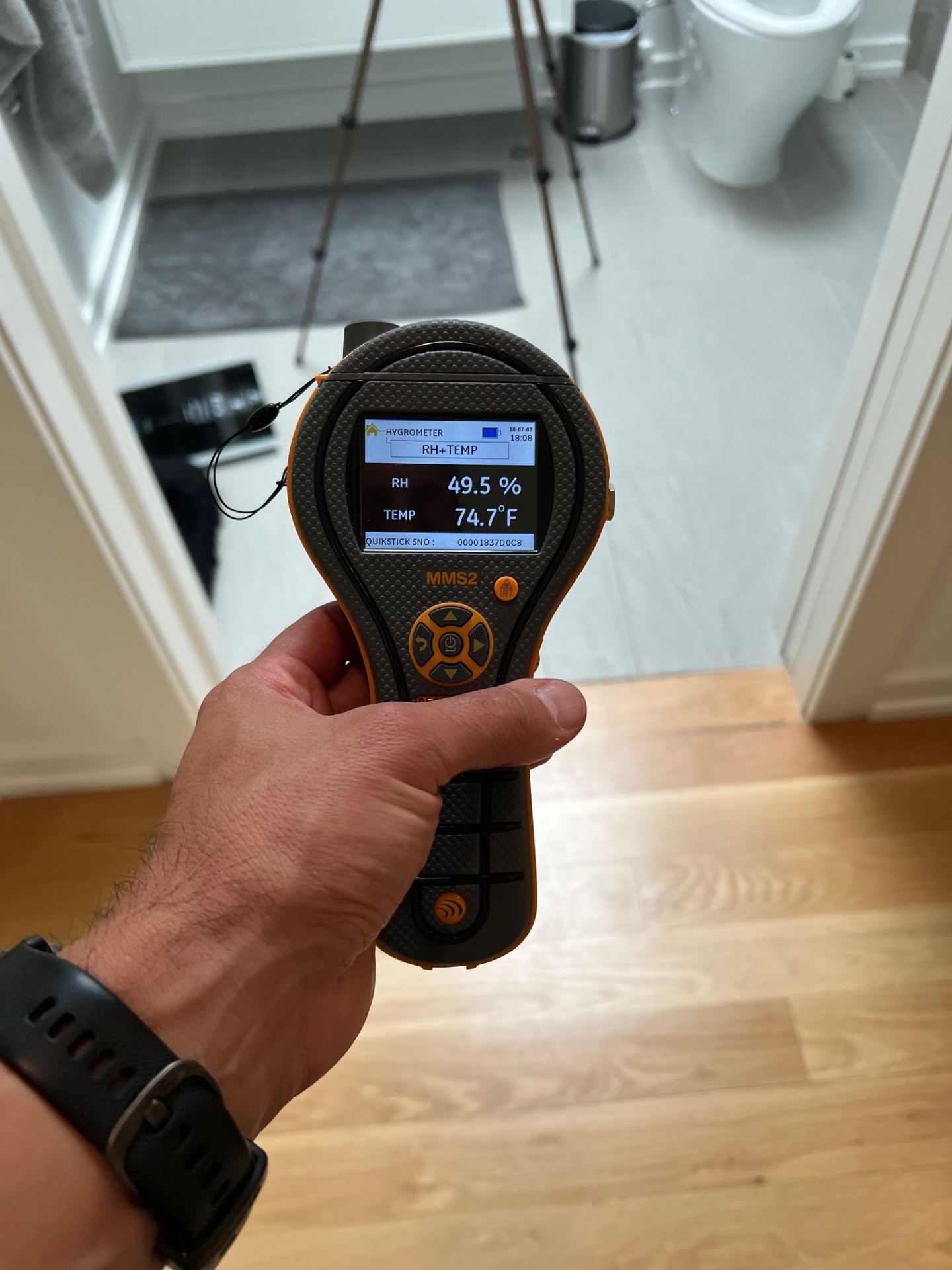 HB&H inspector using a Protimeter MMS2 hygrometer to measure humidity and temperature during a Long Island bathroom mold inspection