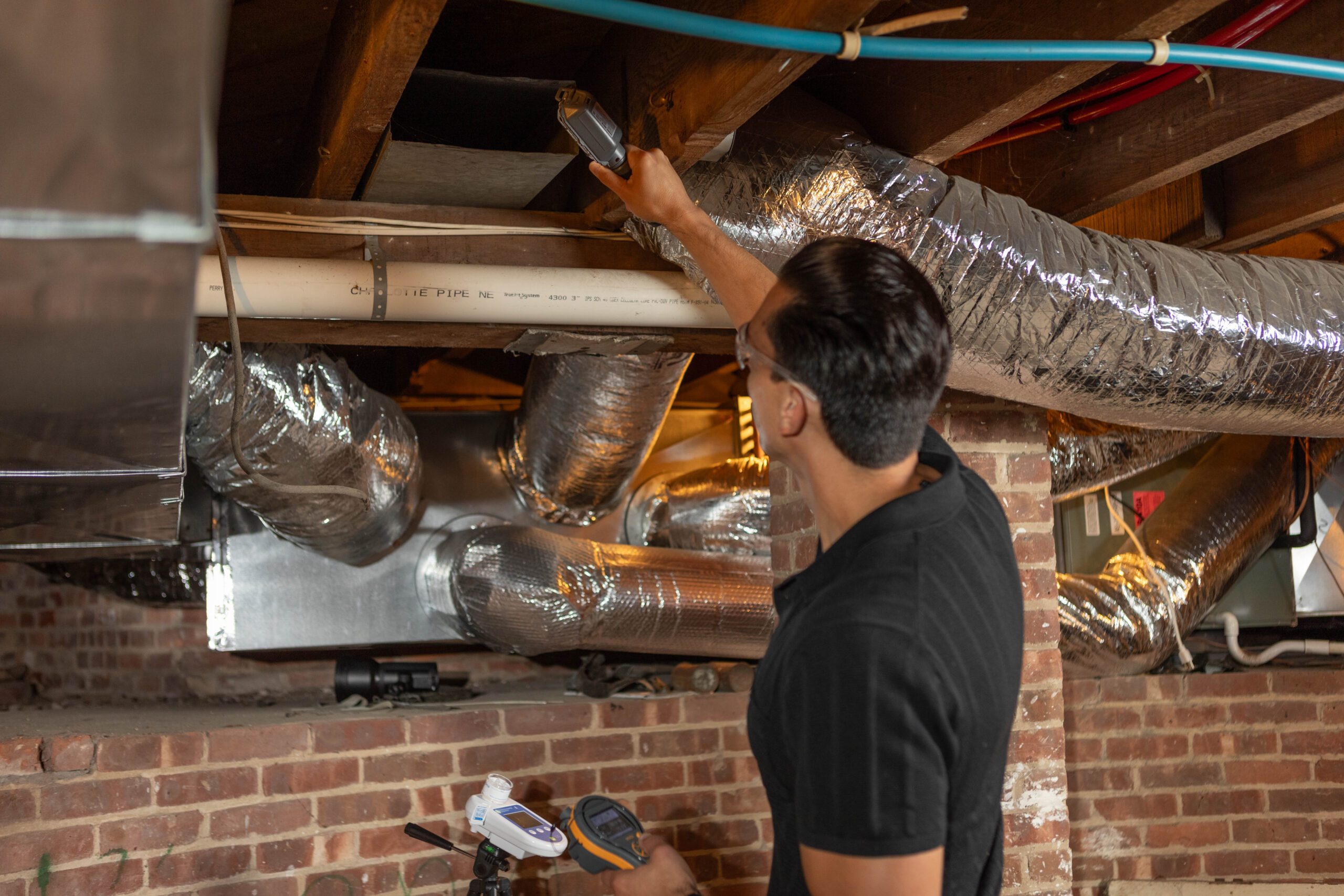 Residential mold inspector reviewing thermal imaging inside a Long Island home